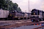 SOU 2660 sits in the yard as a string of "foreign power" rolls by